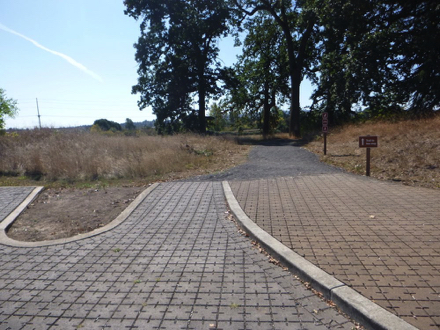 Concrete pavers from the main parking lot and Wildlife Center transitions to a gravel trail to bus stop Concrete pavers from the main parking lot and Wildlife Center transitions to a gravel trail to bus stop